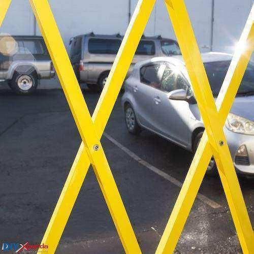 Yellow expandable barrier with adjustable scissor gate design for pedestrian access control