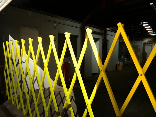 Yellow expandable barrier with adjustable scissor gate design for pedestrian access control