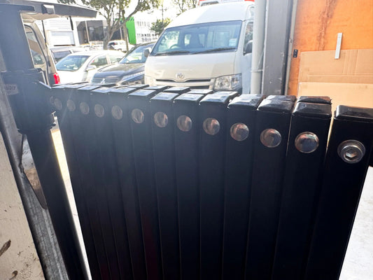 Black expandable barrier with adjustable scissor gate design for access control and safety management