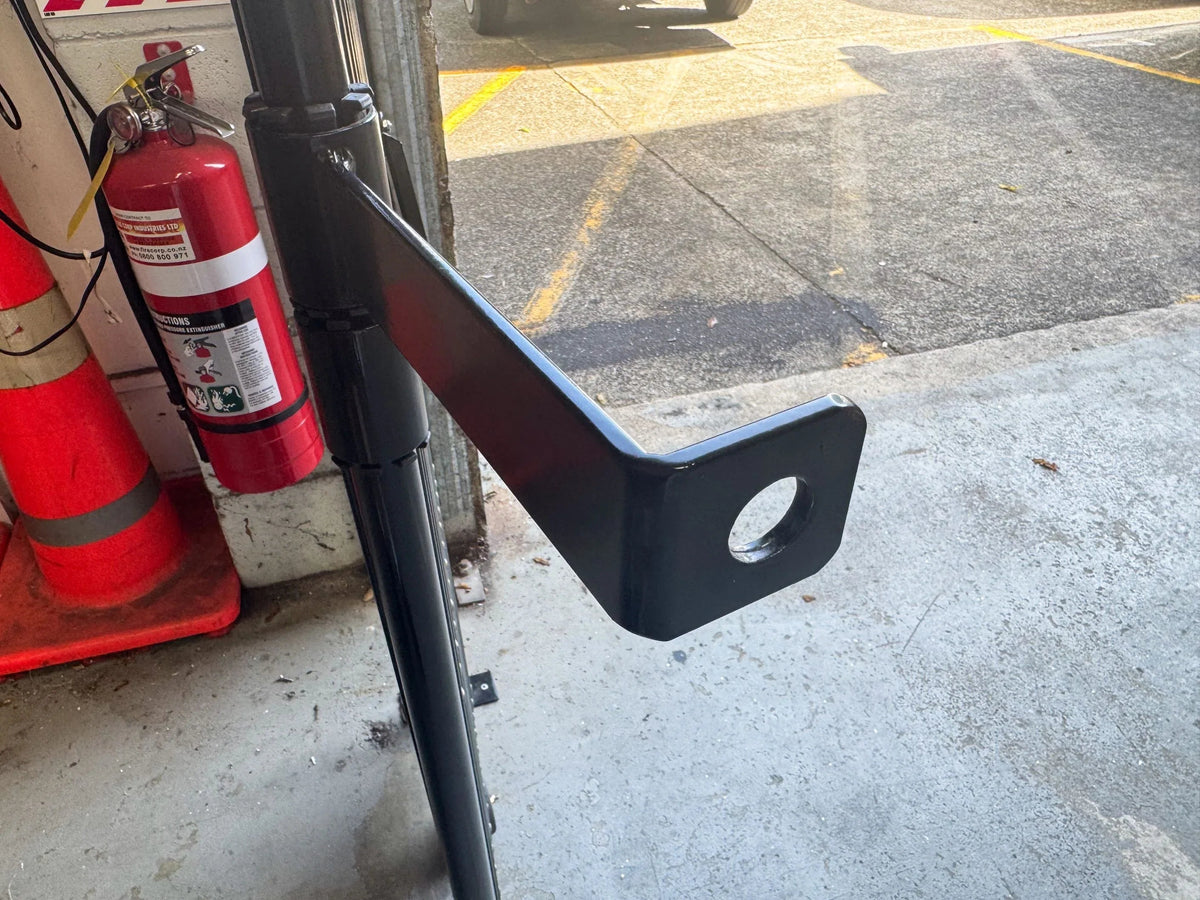 Black expandable barrier with adjustable scissor gate design for pedestrian access control and safety management