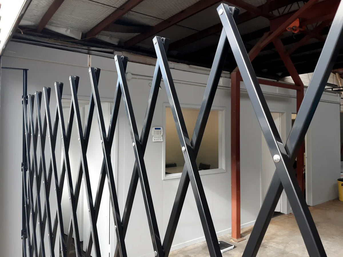 Black expandable barrier with adjustable scissor gate design for access control and safety management