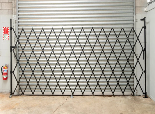 Black expandable barrier with adjustable scissor gate design for access control and safety management