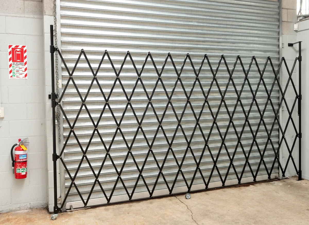 Black expandable barrier with adjustable scissor gate design for access control and safety management