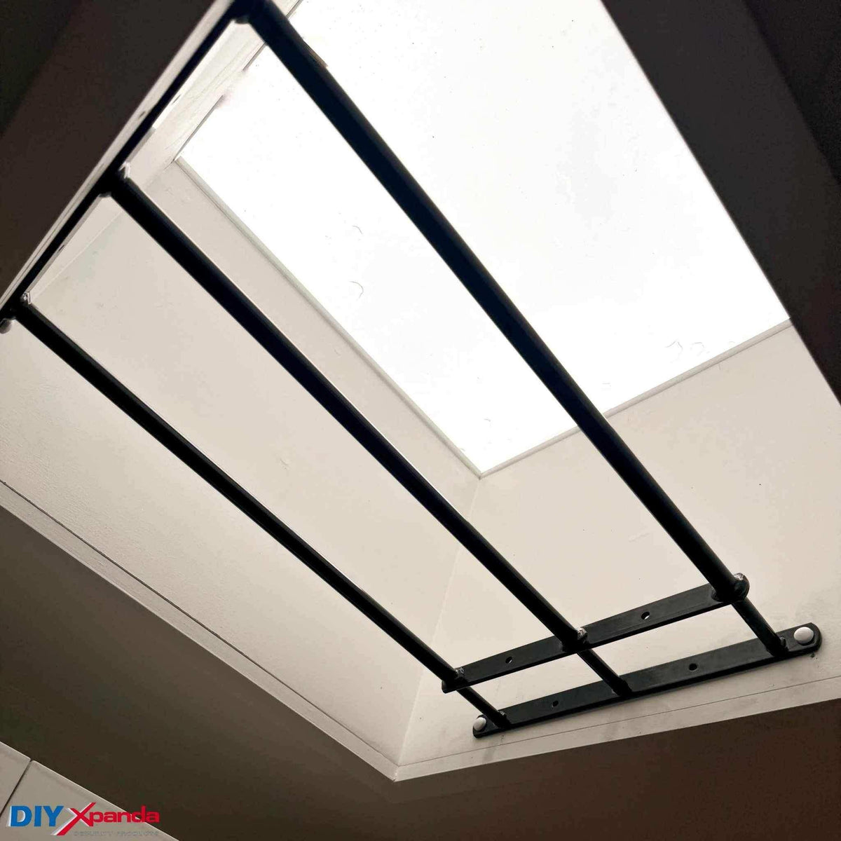 Black extendable steel window bars installed on a residential window for security protection