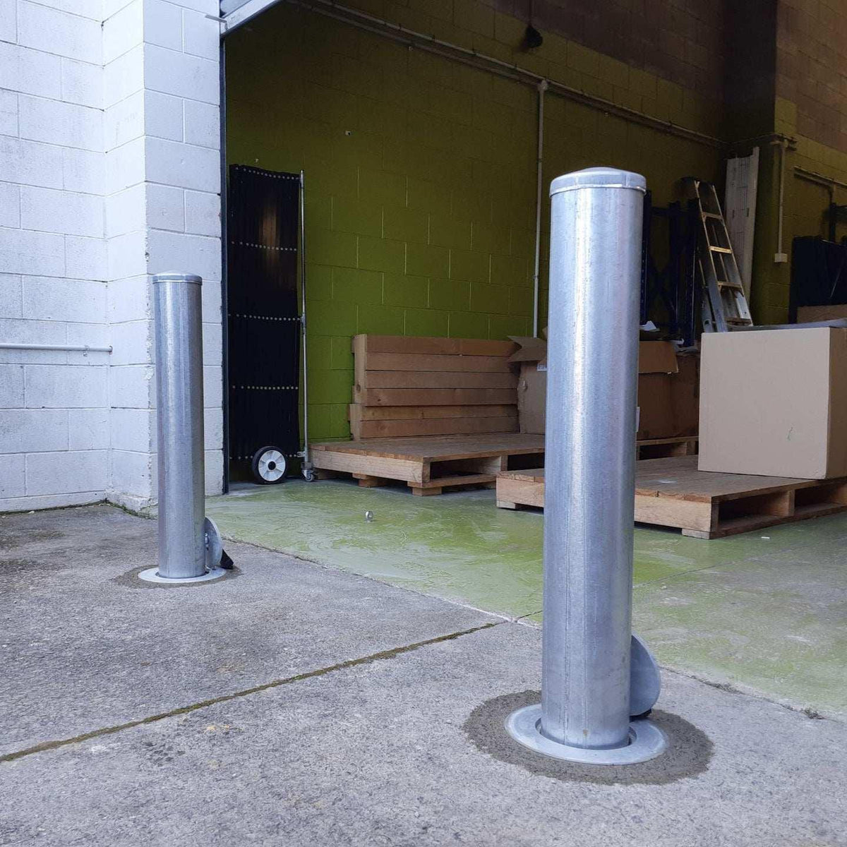 Removable bollards pipe and base set installed in residential driveway