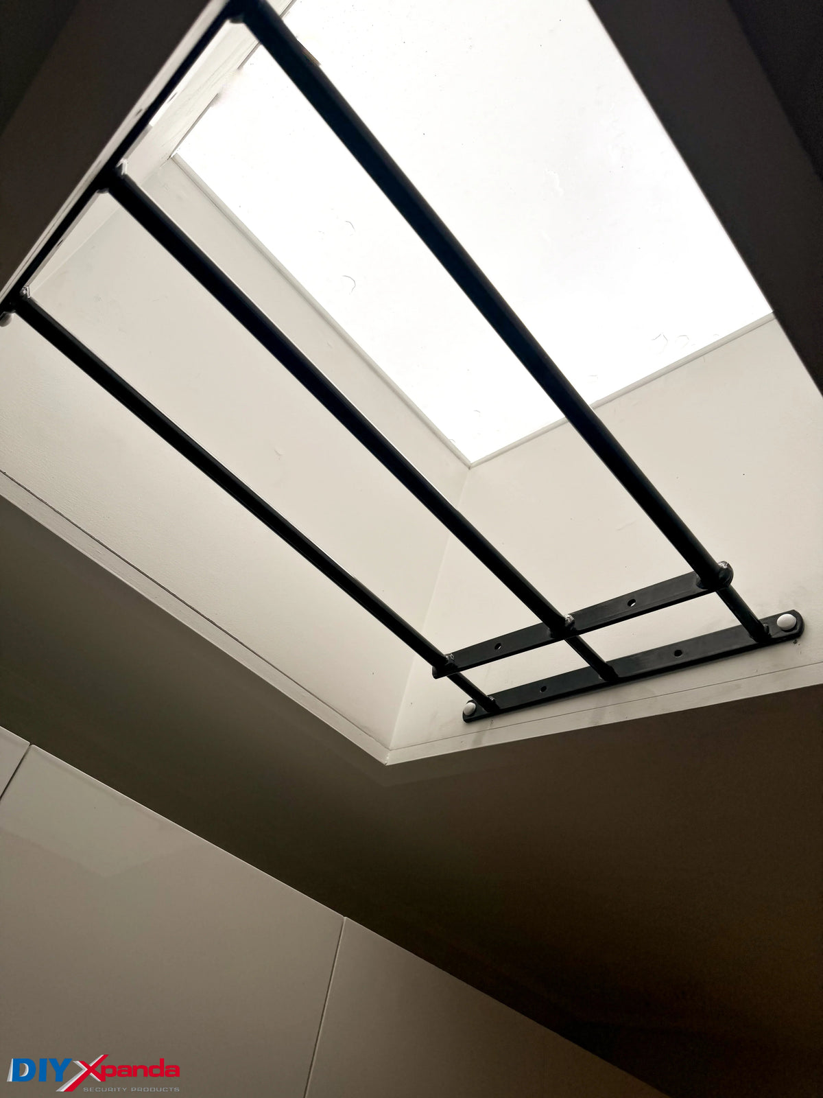 Black extendable steel window bars installed on a residential window for security protection