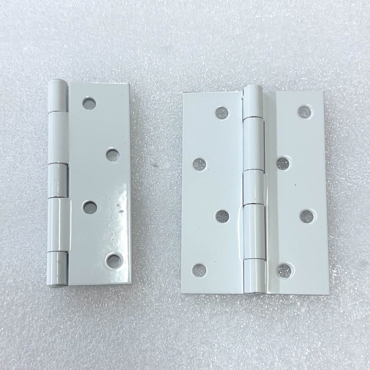 Hinges of the Saftidor retractable security grille installed on residential doorway